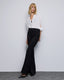 FLARE PANTS WITH FAUX LEATHER EFFECT PIPING DETAILS